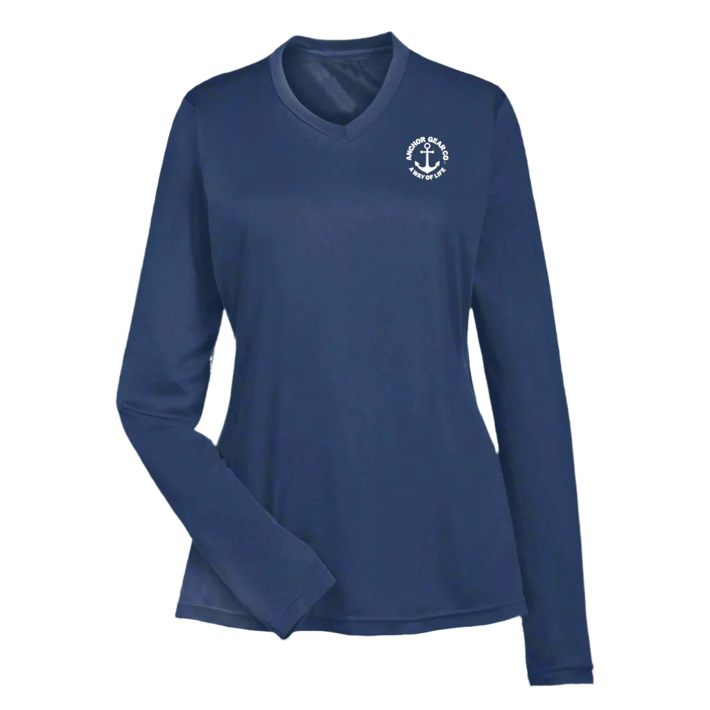 A navy blue long sleeve performance shirt for women with a unique anchor design on the chest, displayed against a white backdrop