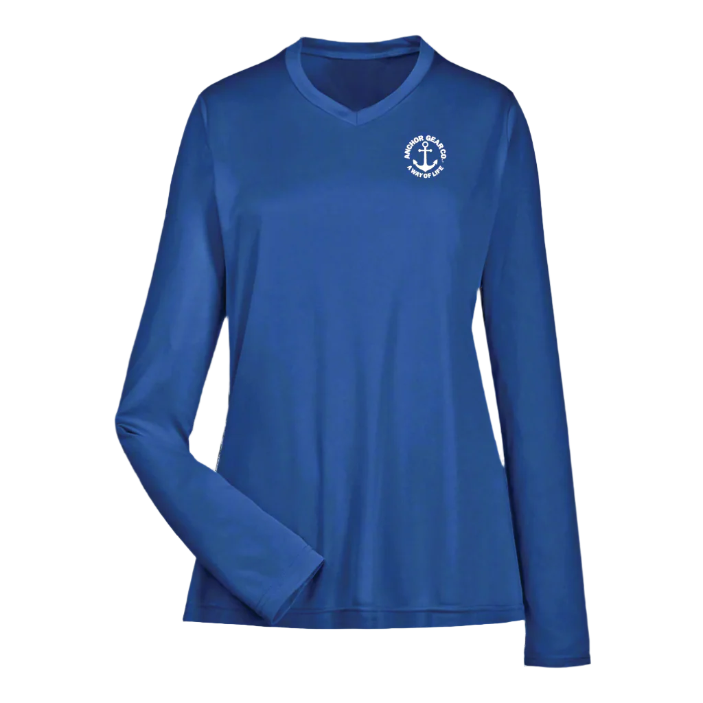A royal blue long sleeve performance shirt for women with a unique anchor design on the chest, displayed against a white back drop