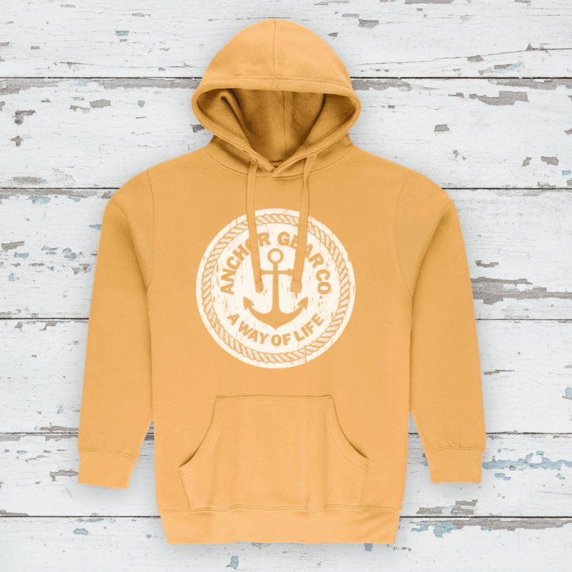 A mustard hoodie featuring a central logo on the chest that contains an anchor and the text 'A Way of Life' surrounding a circular frame.