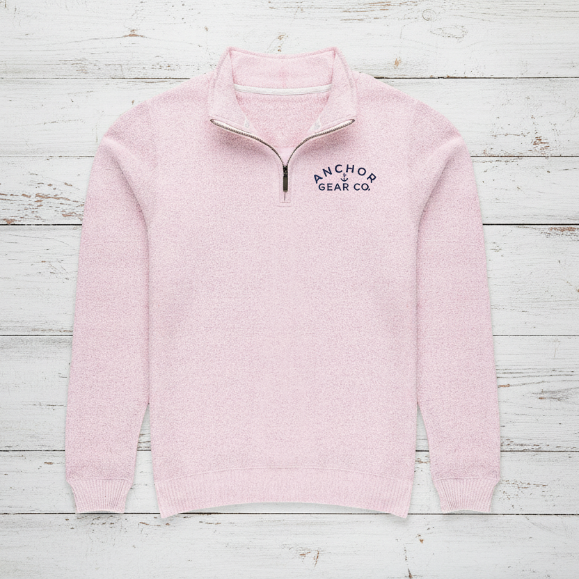 Pink half-zip sweater with 'Anchored Gear Co' logo on a white background