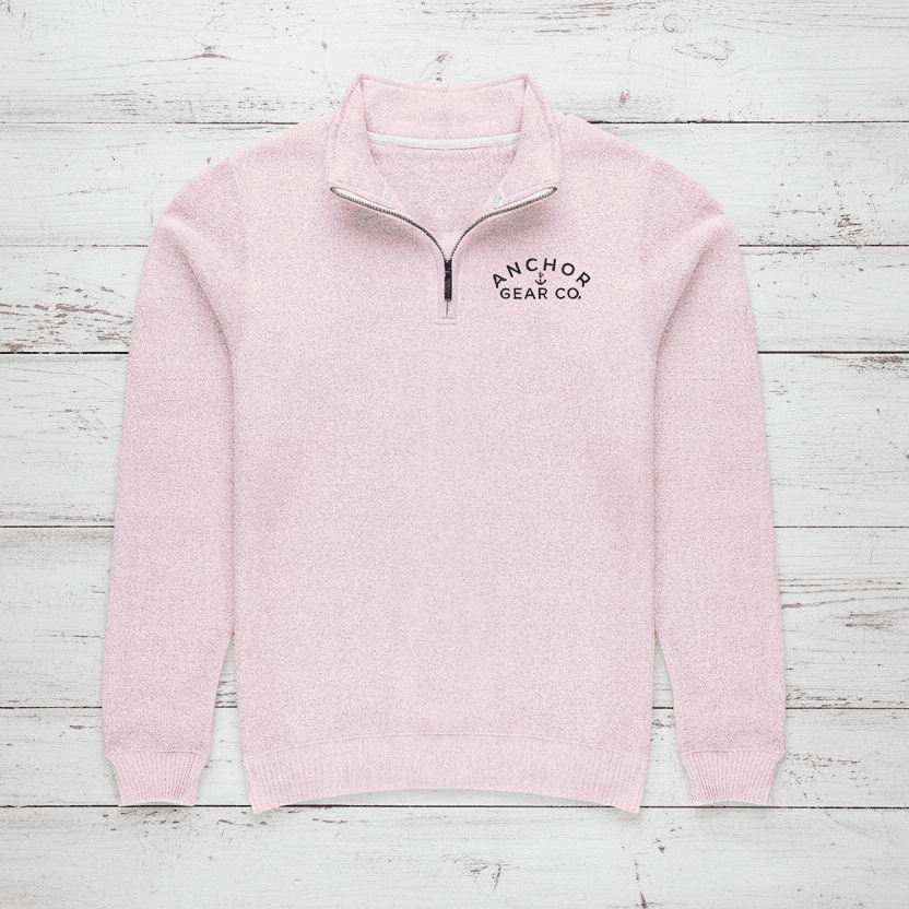 Pink half-zip sweater with 'Anchored Gear Co' logo on a white background