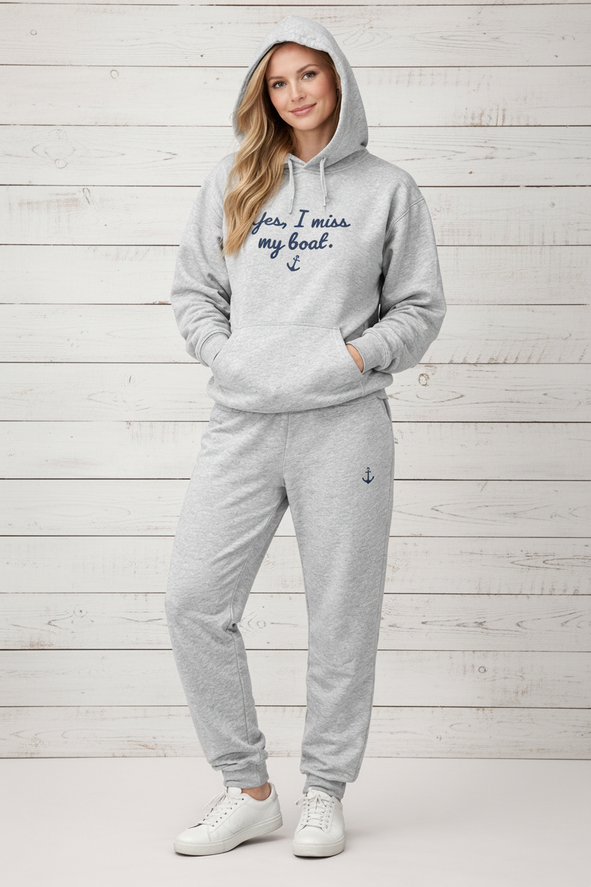 Person wearing a gray hoodie and pants with text and an anchor on a white background