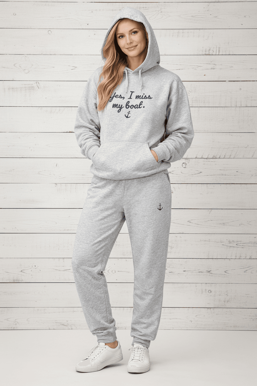 Person wearing a gray hoodie and pants with text and an anchor on a white background