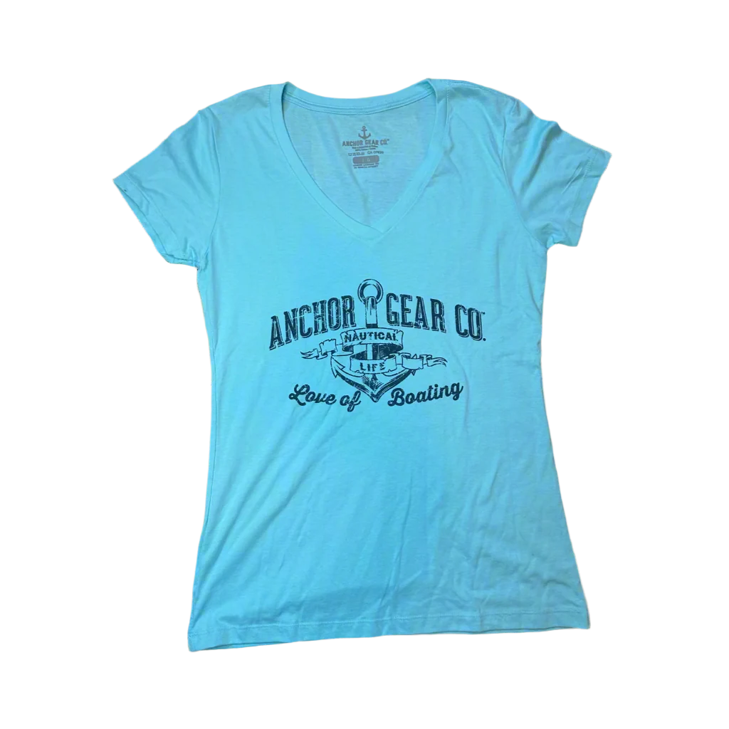 A teal blue fitted women's t-shirt with a v-neck, featuring a white graphic print of an anchor and text, displayed on a wooden surface.
