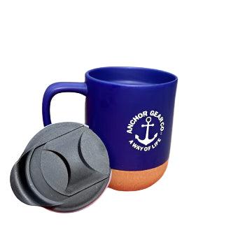 A navy-colored ceramic mug with a cork bottom and a black secure sip lid, featuring the Anchor Gear Co. logo.