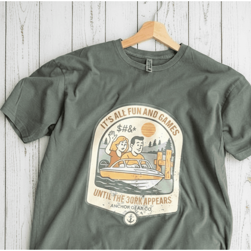 Green t-shirt with graphic design on a wooden surface