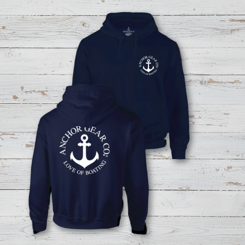 Navy blue hoodie with anchor logo on a wooden background
