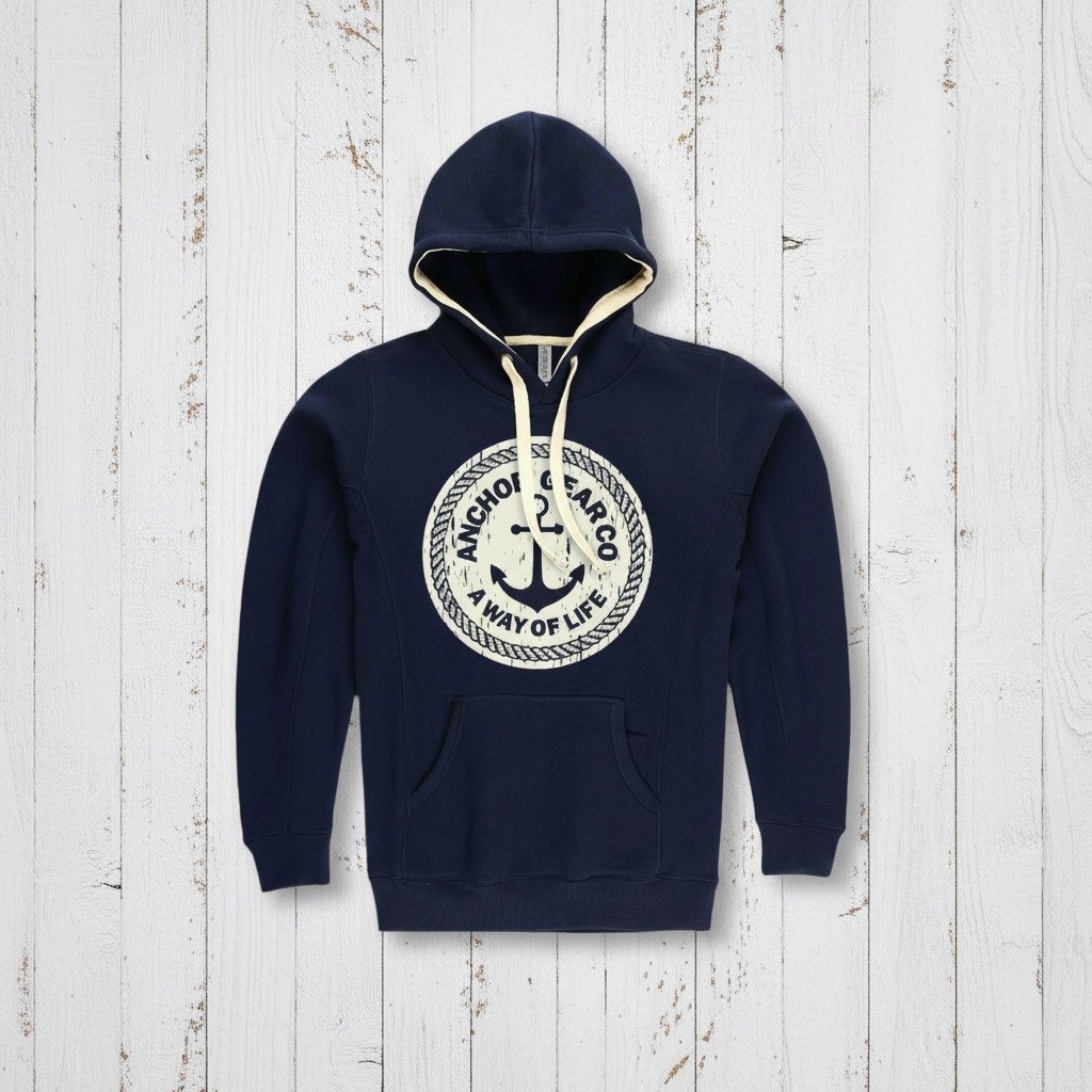 A navy blue hoodie with a hood, featuring a vintage anchor logo in a larger circle, with a smaller circle inside it containing the text 'A WAY OF LIFE'. The hoodie appears to have a front pocket and is displayed against a wooden background.