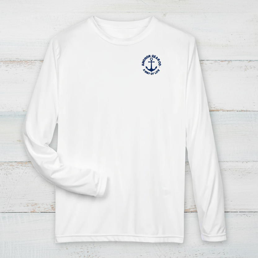 A white long sleeve performance shirt with a anchor design on the chest, displayed on a off white background