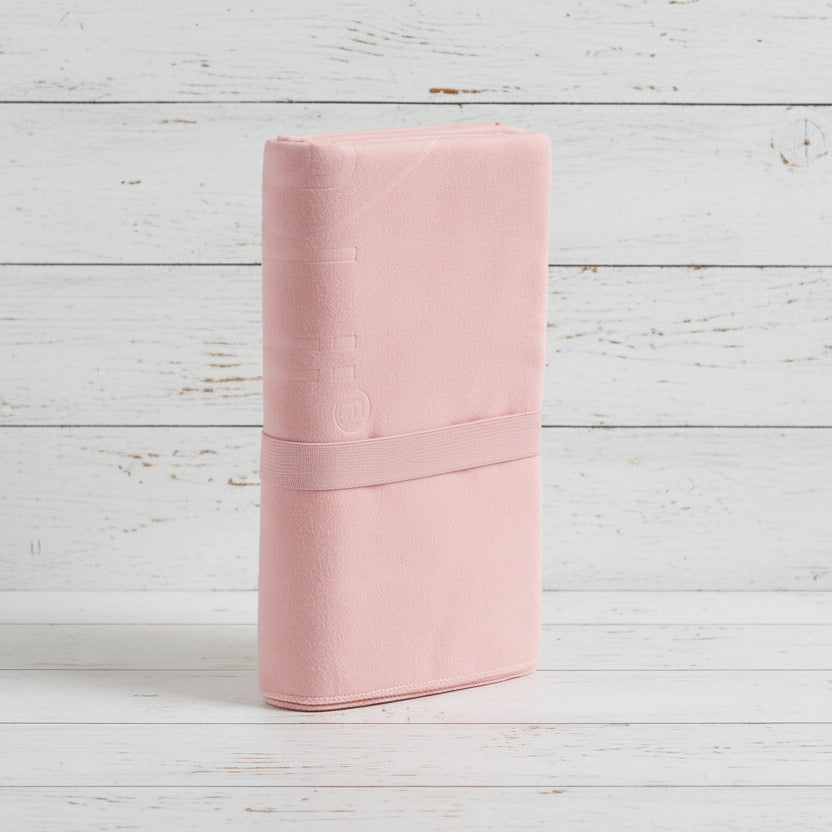 Pink fabric roll on a light gray background