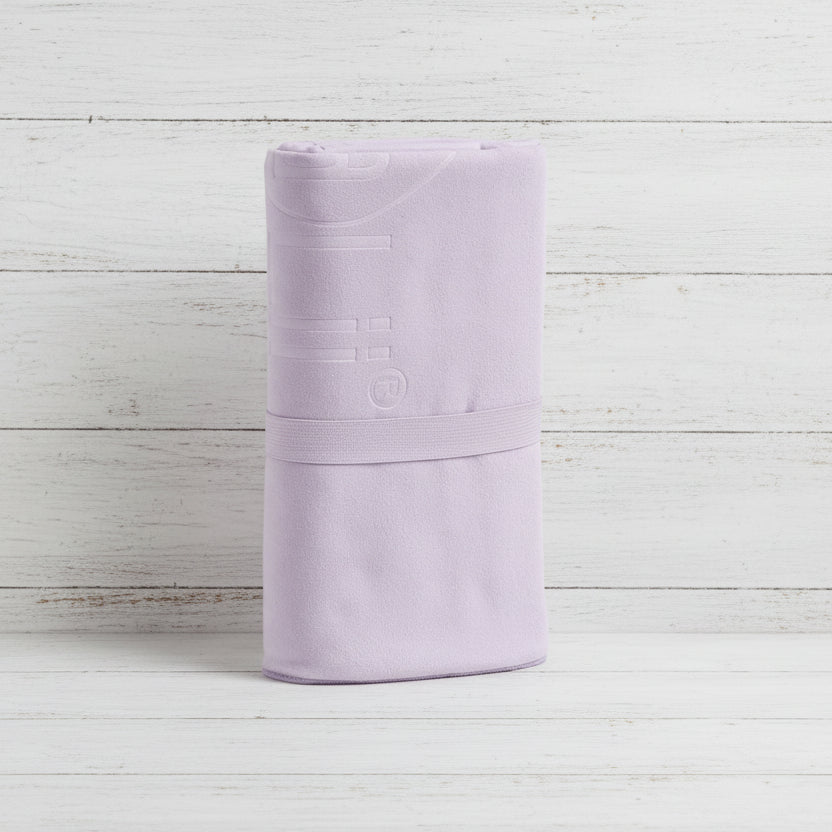 Folded light purple fabric on a white background