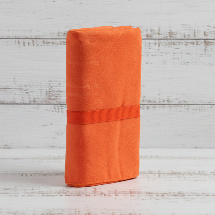 Orange fabric roll with a strap on a light gray background