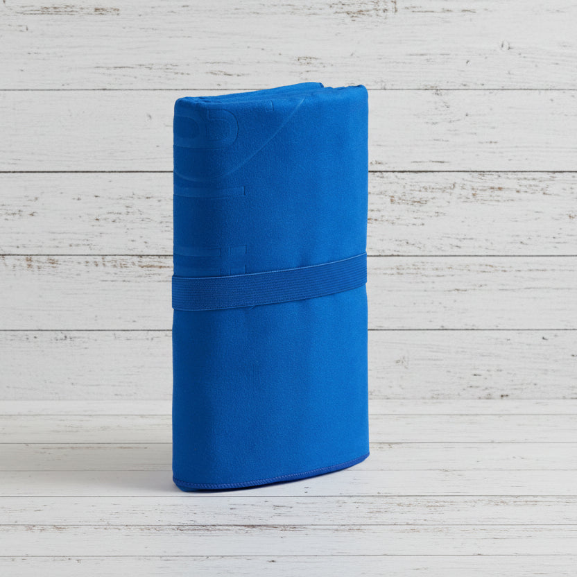 Folded blue fabric with a strap on a light gray background