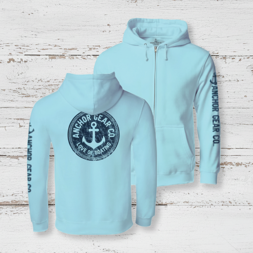 Two light blue full zip hoodies with an anchor logo on a wooden platform with a white background